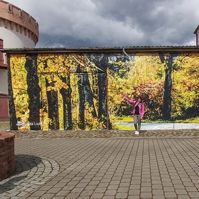 Fotografė, kuri skuba išsitraukti fotoaparatą kelyje pasiekusi posūkį